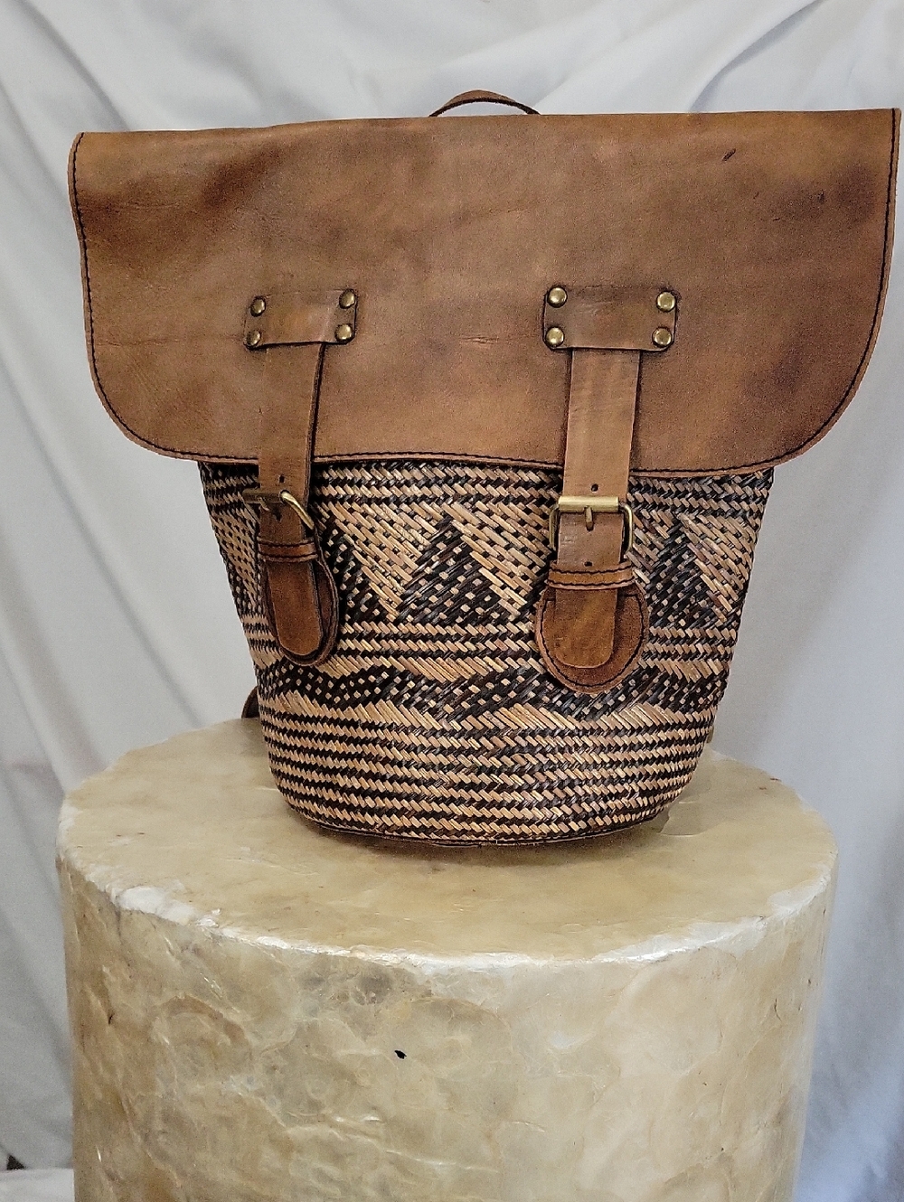 Rustic woven rattan and leather backpack